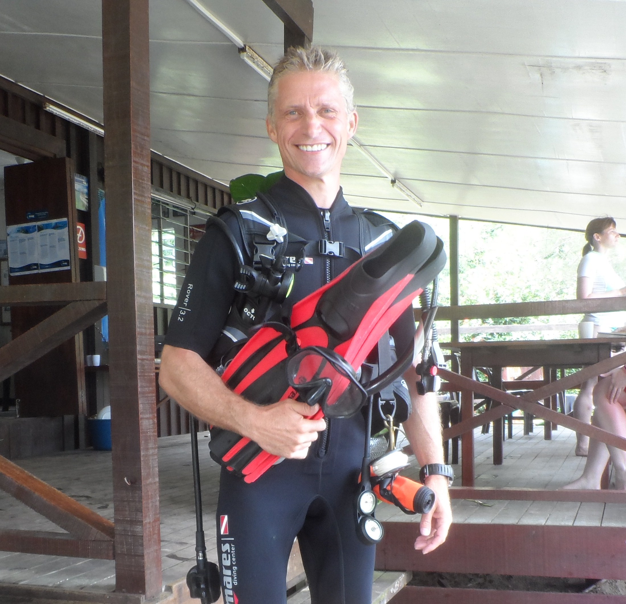 Man scuba diving among fish